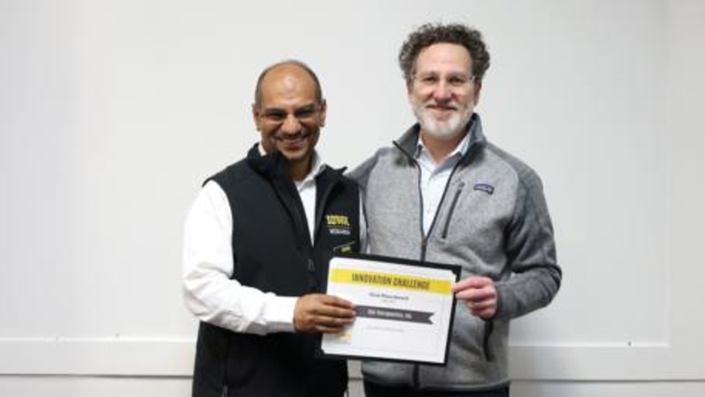 Two men holding sign that says Innovation Challenge Winner